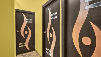 A hallway with three doors, each with a unique abstract design.