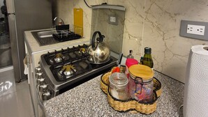 A kitchen with a gas stove, a kettle, a sink, and various kitchen items on the counter. - "Casa Mia" in San Miguel with all the amenities for a peaceful and pleasant stay (San Miguel)