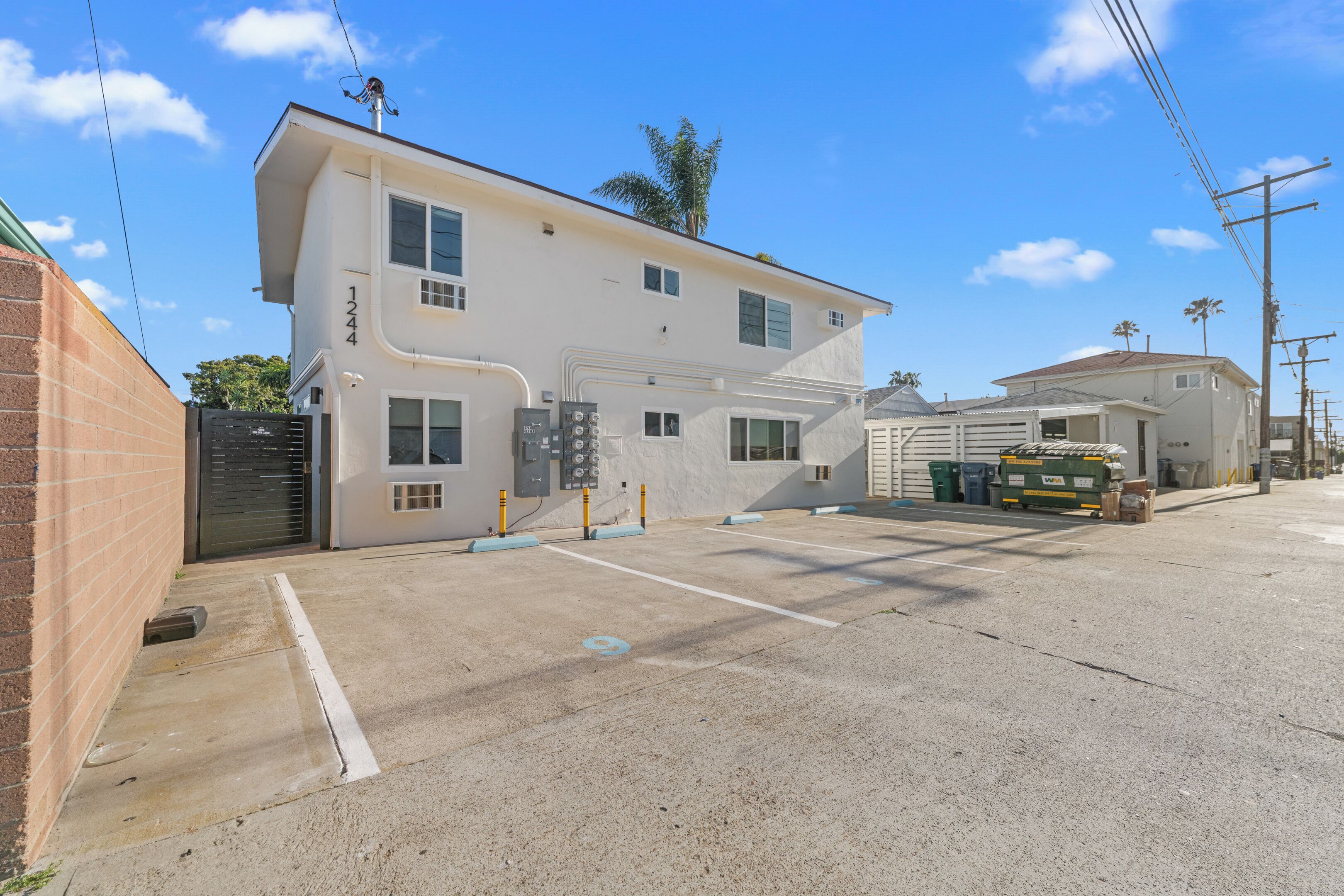 A two-story building with a garage and a covered parking area.