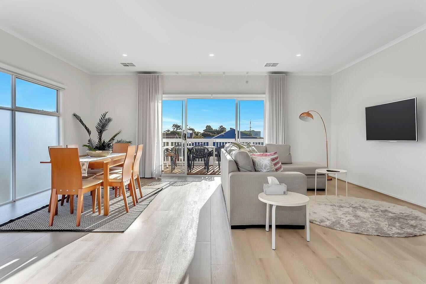 Move seamlessly through open-plan living, where lounge and dining connect in a bright, social space designed for gathering.