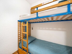 A bunk bed with a wooden ladder, a blue mattress, and a white wall. - Studio with Wi-Fi, sea view for 4 people (Roquebrune-Cap-Martin)