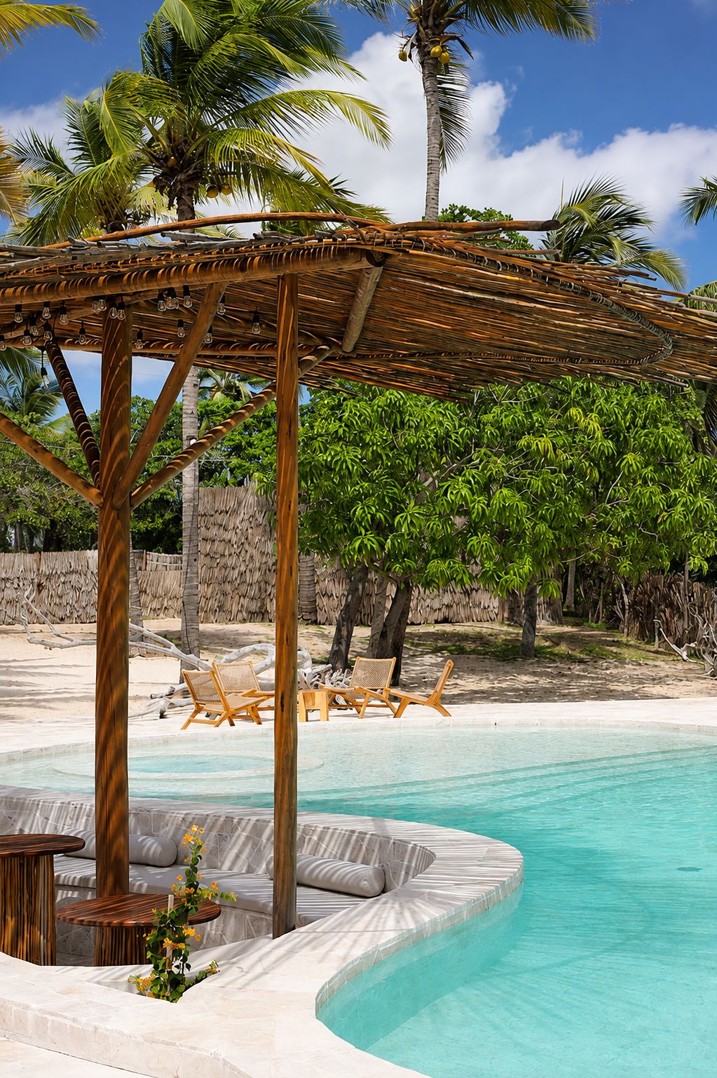 A pool area with a wooden pergola, lounge chairs, and a clear blue pool.