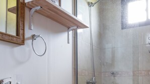 A bathroom with a toilet, sink, and shower.