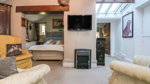 A cozy living room with a fireplace, a television, and comfortable seating.