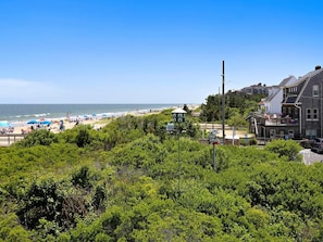 A coastal view with a beach, a gazebo, and residential buildings. - Oceanfront 4BR Condo w/ Decks & BBQ | Sleeps 9! (Bethany Beach)