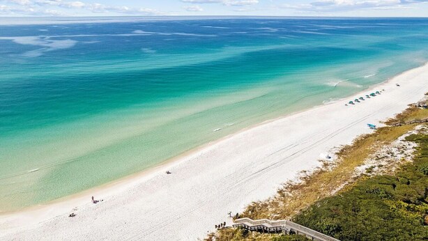A beach with clear turquoise waters, a sandy shore, and a few umbrellas. - Bikes*Pool&Hottub*Walk2Beach (Santa Rosa Beach)