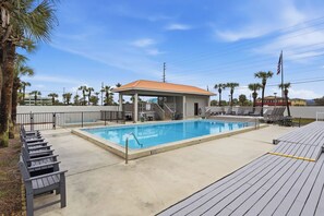 A swimming pool with a covered area, lounge chairs, and a deck. - 1st floor gulf-front condo in Ft Walton Bch FL (Fort Walton Beach)
