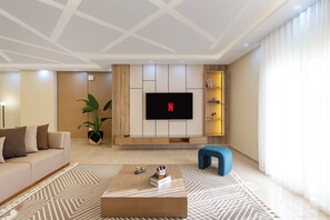 Deluxe Apartment, 2 Bedrooms, Balcony | Living area | 65-inch LED TV with satellite channels - Beithady Luxury Aparthotel Lotus - BH-73 (New Cairo)
