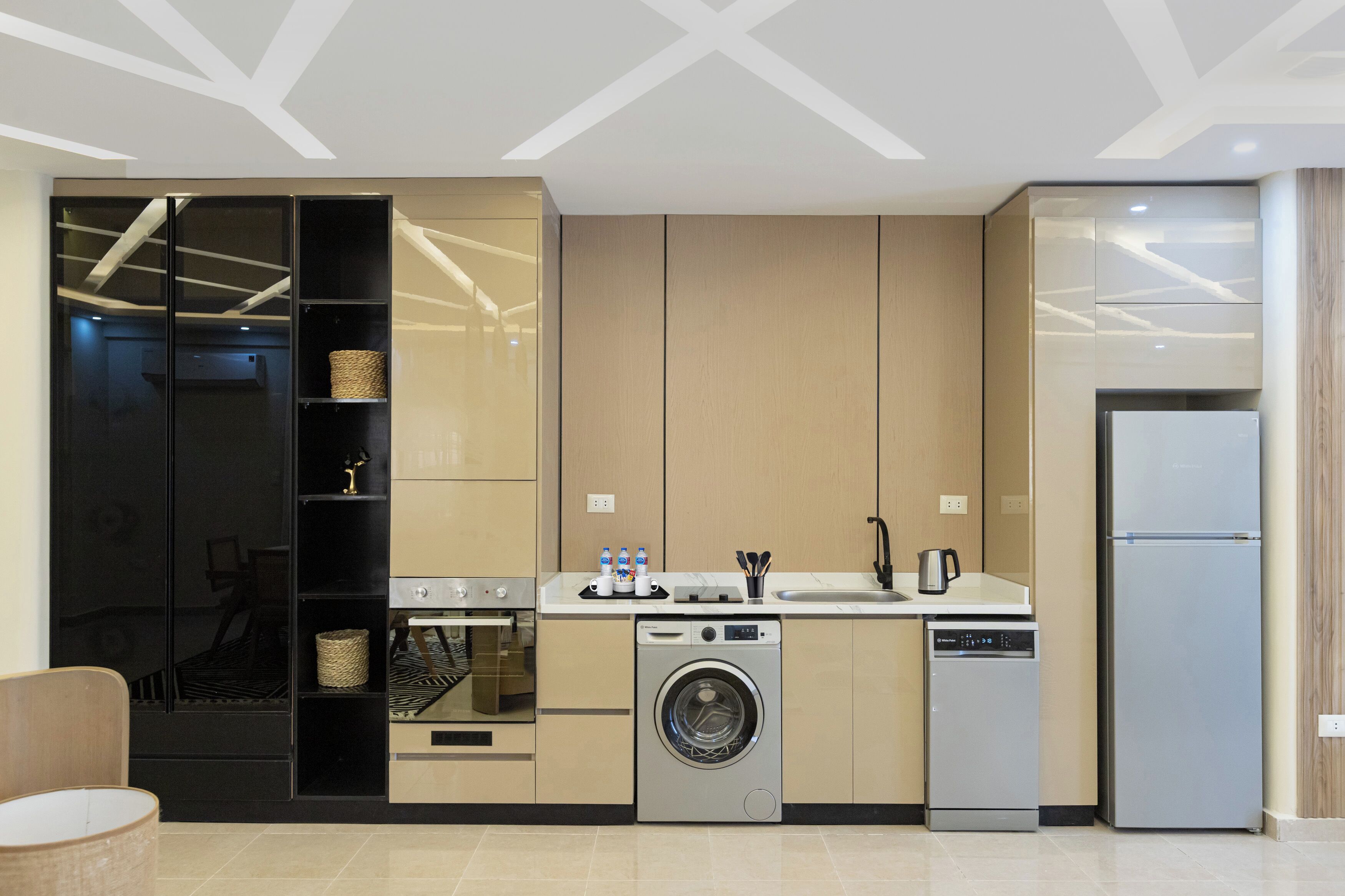 A modern kitchen with built-in appliances, a washing machine, and a dishwasher.