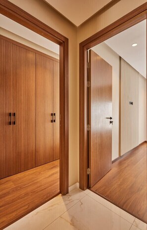 A hallway with wooden doors and a tiled floor. - Discover Casa: Stay in our 3-Bed Gem with Parking (Casablanca)