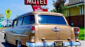 A vintage car parked in front of a motel with a 'Fiesta Motel' sign. - Siesta Inn (Salt Lake City)