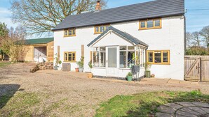 A two-story house with a gabled roof, a front porch, and a garage. - Spacious 4-Bed in Peaceful Market Drayton - Pass the Keys (Lockleywood)