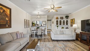 A living room with a sofa, a coffee table, a TV, and a ceiling fan. - Canyon Lake Retreat w Deck, Grill & Deer Views! (Canyon Lake)