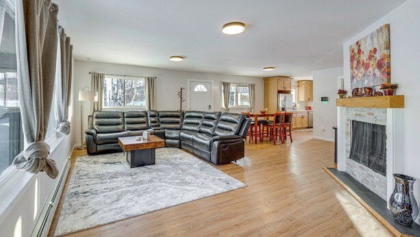 A modern living room with a sectional sofa, a coffee table, and a fireplace. - Walkable Adventure Base in Midtown Anchorage (Anchorage)
