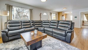A modern living room with a sectional sofa, a wooden coffee table, and a patterned rug. - Walkable Adventure Base in Midtown Anchorage (Anchorage)