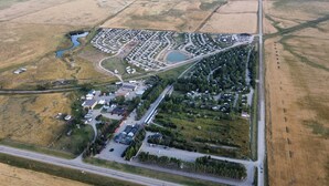 Vista aérea de una zona residencial con casas, calles y un lago pequeño.
