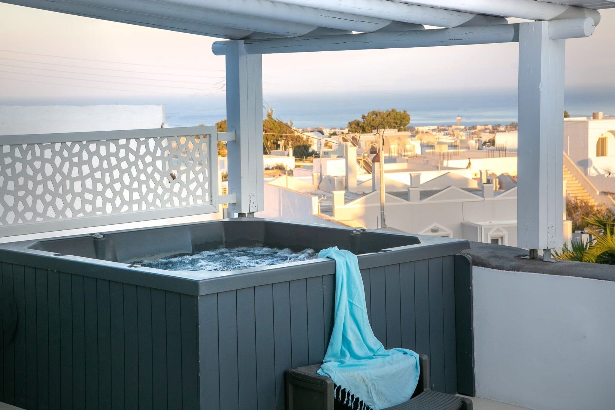 A hot tub with a view of a cityscape.