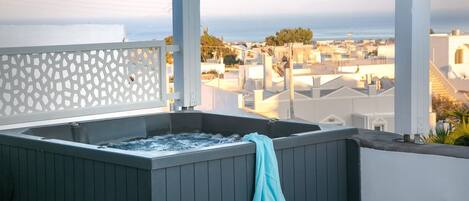 A hot tub with a view of a cityscape.