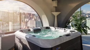 A hot tub with a city view, large windows, and a modern architectural design. - Beautiful Studio República DelSalvador (Quito)