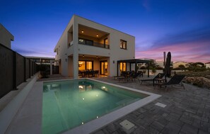 A modern two-story house with a swimming pool, outdoor seating, and a covered patio. - Awesome home in Vodice (Vodice)