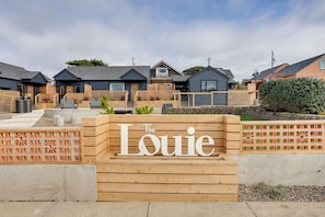 A wooden sign with "The Louie" written on it, indicating a hotel or lodging establishment. - The Louie Boutique Motel (Newport)