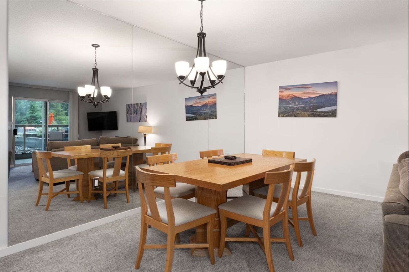Host lively dinners at the spacious table with mirrored light.