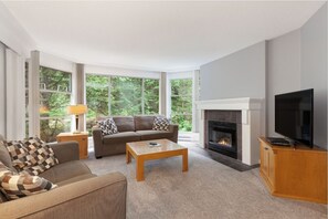 TV, fireplace - Blackcomb Mountain Retreat| Ski in/out Location | with Pool and Hot Tub (Squamish-Lillooet)