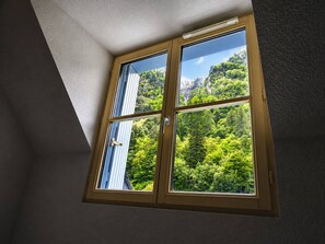 A room with a window overlooking a forested area. - Duplex with parking - 5 guests (Cauterets)