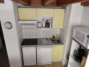 A compact kitchen with a sink, two dishwashers, a microwave, and a clock on the wall. - Duplex with parking - 5 guests (Cauterets)