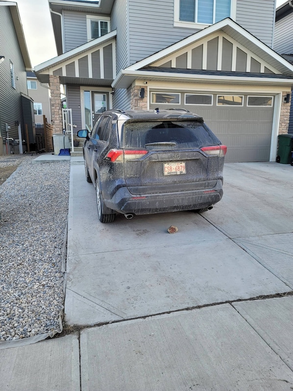 A residential driveway with a parked SUV.