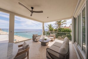 A spacious balcony with a view of the ocean, furnished with a sofa, chairs, and a coffee table. - Casa Nautilus (Cabo San Lucas)