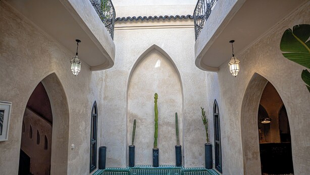 A courtyard with a central fountain, arched alcoves, and hanging lanterns. - Authentic Marrakech Riad in the Heart of the Medina (Marrakesh)