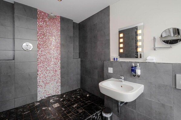 A modern bathroom with a shower, a sink, and a mirror. - Fishmore Hall Hotel and Boutique Spa (Ludlow)