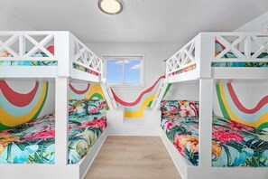 Fun bunk room with colorful decor and multiple sleeping spaces, perfect for children and large groups staying at this family friendly beach house. - Beachfront + Hot Tub | Putt-Putt | Pet-Friendly (Galveston)