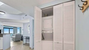 Eine moderne Wohnung mit begehbarem Kleiderschrank, einer Küchenzeile und einem Wohnbereich mit Blick.