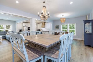 A spacious kitchen with a large island, white cabinetry, and a chandelier. - Grand Opening June 13! New 6BR/5.5 Bath Luxury - Sleeps 18 - 4 rows to the Beach (Hilton Head Island)