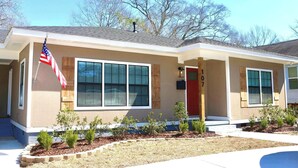 A two-story house with a red door, number 107, and an American flag. - Welcome to University Place (Ruston)