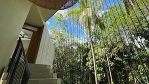 A staircase with a woven ceiling fan, surrounded by a metal fence and tropical plants. - The Sevana (Matara)