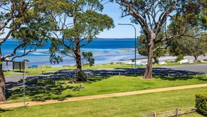 A coastal park with pathways, benches, and informational signs. - The Bay House - Fireplace - Waterfront (Callala Bay)
