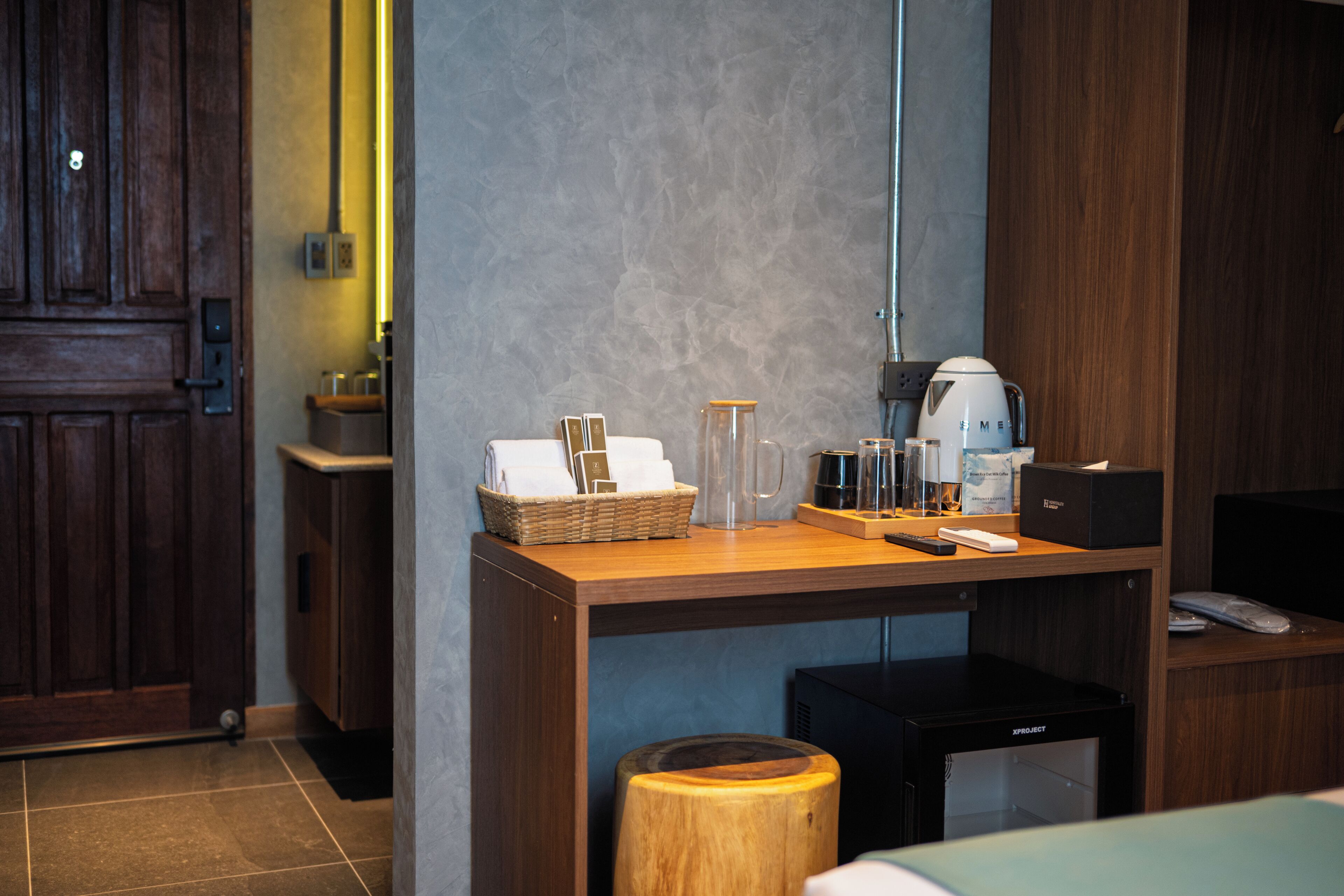 A modern kitchen with a wooden countertop, a coffee machine, and a small black appliance.