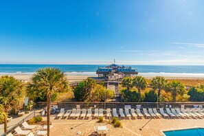A beachside hotel with a pool, lounge chairs, and a view of the ocean. - Yachtsman S402 Studio (Myrtle Beach)