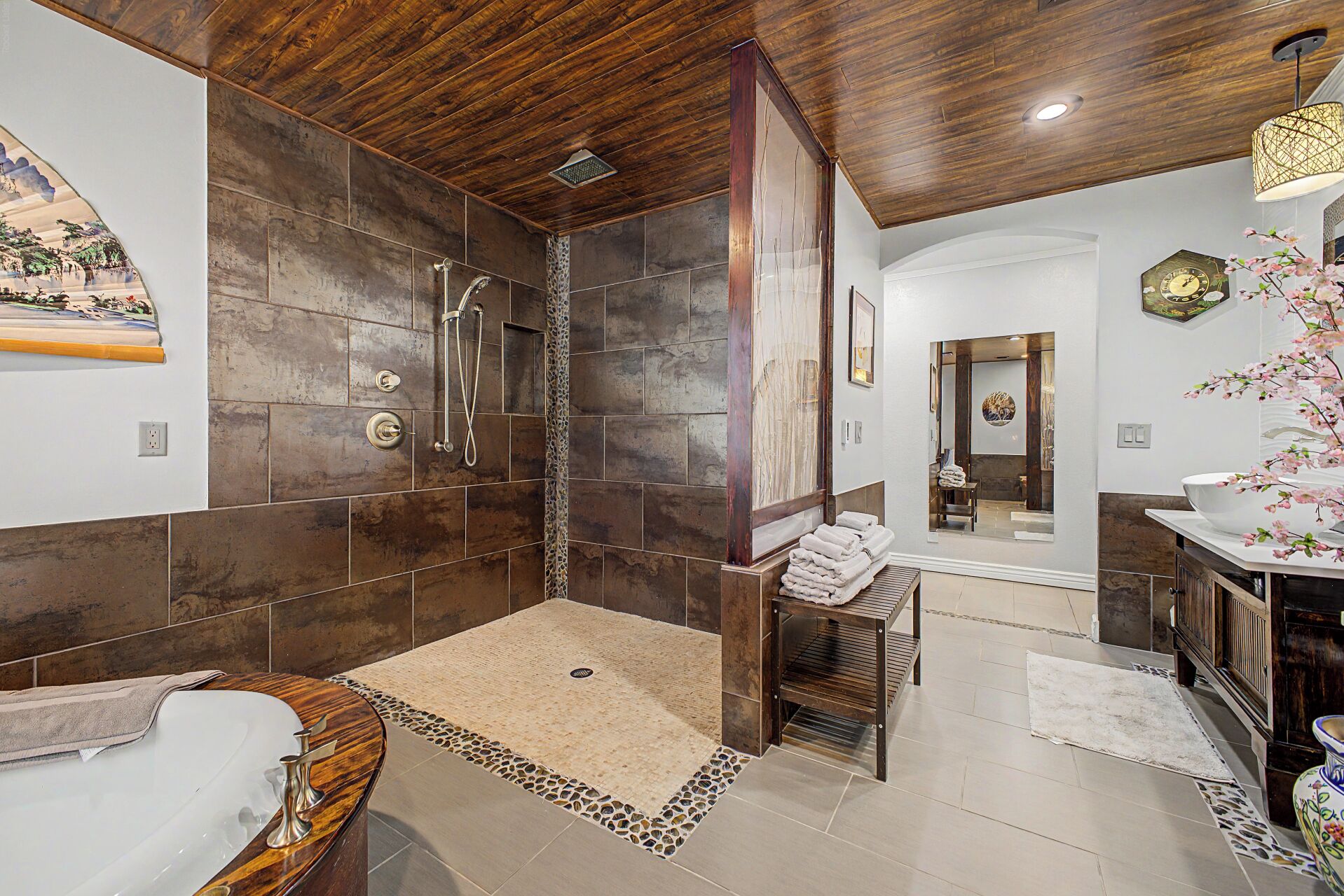 A bathroom with a shower, bathtub, and vanity.