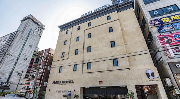 A hotel with a prominent 'MARI HOTEL' sign, multiple windows, and a visible entrance. - MARI Hotel (Incheon)