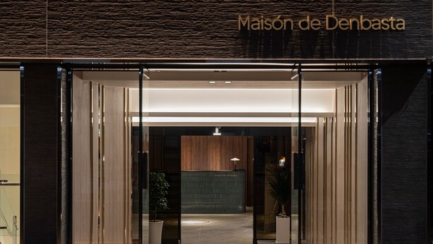 The entrance to Maison de Denbasta with a modern design, featuring glass doors and a wooden interior. - Maison de Denbast (Busan)