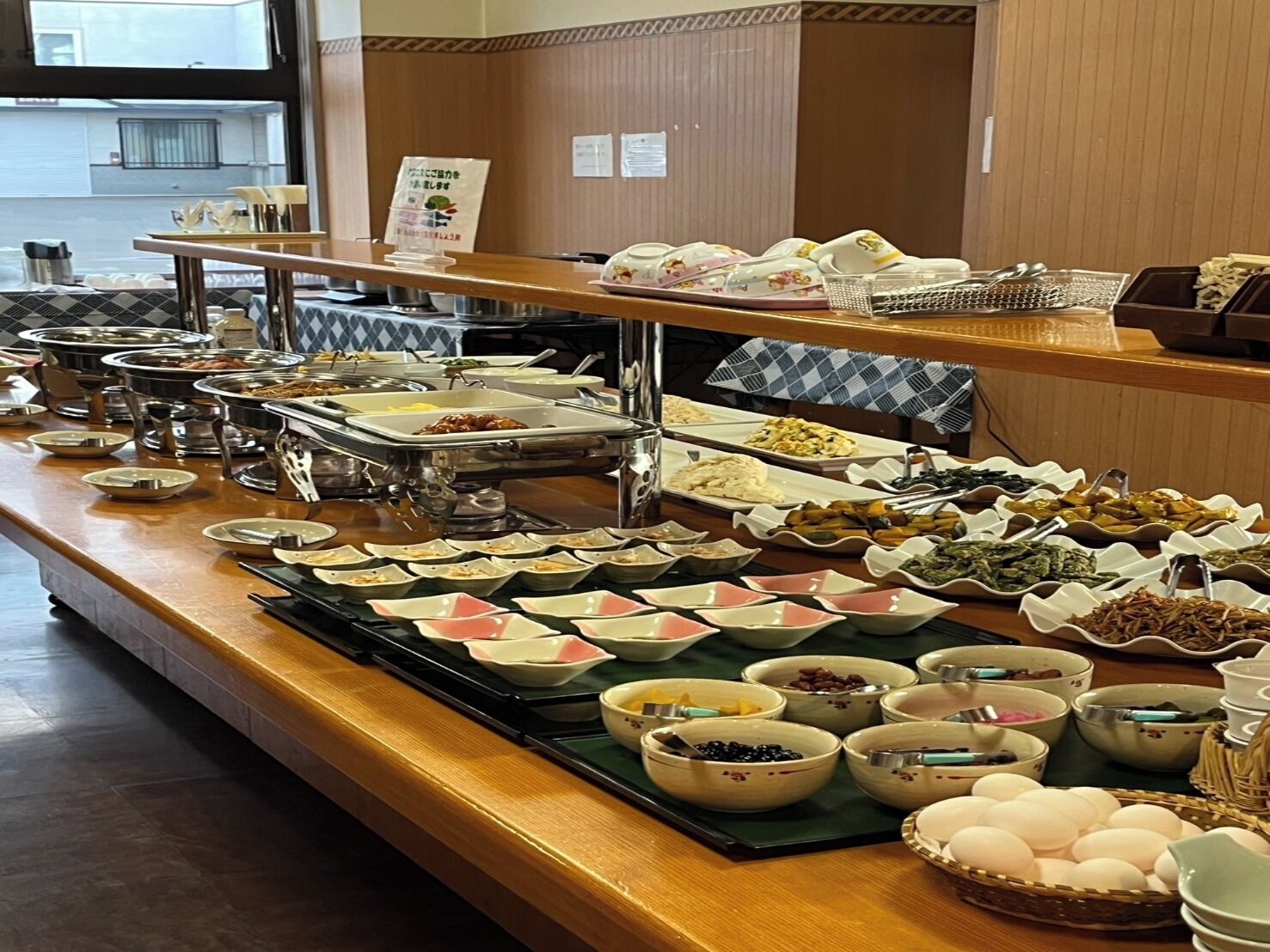A buffet with various dishes and utensils.