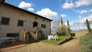 A villa with a patio, outdoor seating, and a view of the countryside. - Farmhouse in Tuscany With Pool & Valley Views (Poppi)