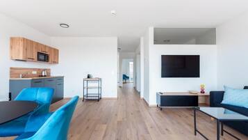 Apartment, Balcony, City View | Living area | Flat-screen TV
