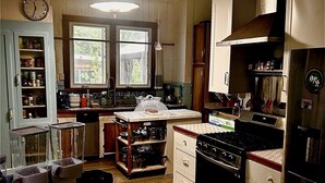 A kitchen with wooden cabinets, a stove, and a refrigerator.