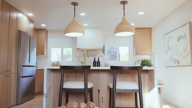 A modern kitchen with wooden cabinets, stainless steel appliances, pendant lighting, and a marble countertop. - Playful Luxury - Pool, Games & Near Old Town (Scottsdale)