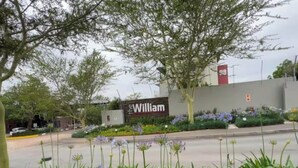 A sign for 'The William' hotel with a landscaped garden in the foreground. - Dainfern Luxury Penthouse (Midrand)